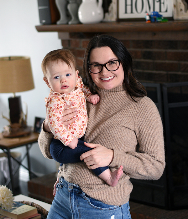 woman with glasses holding daughter