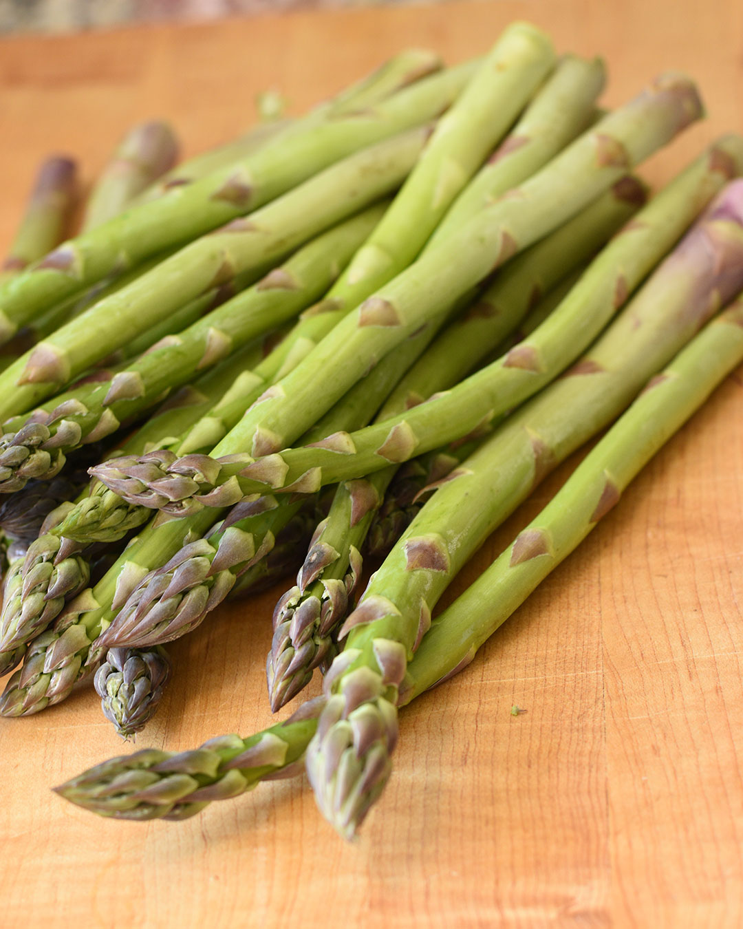 fresh asparagus on cutting board