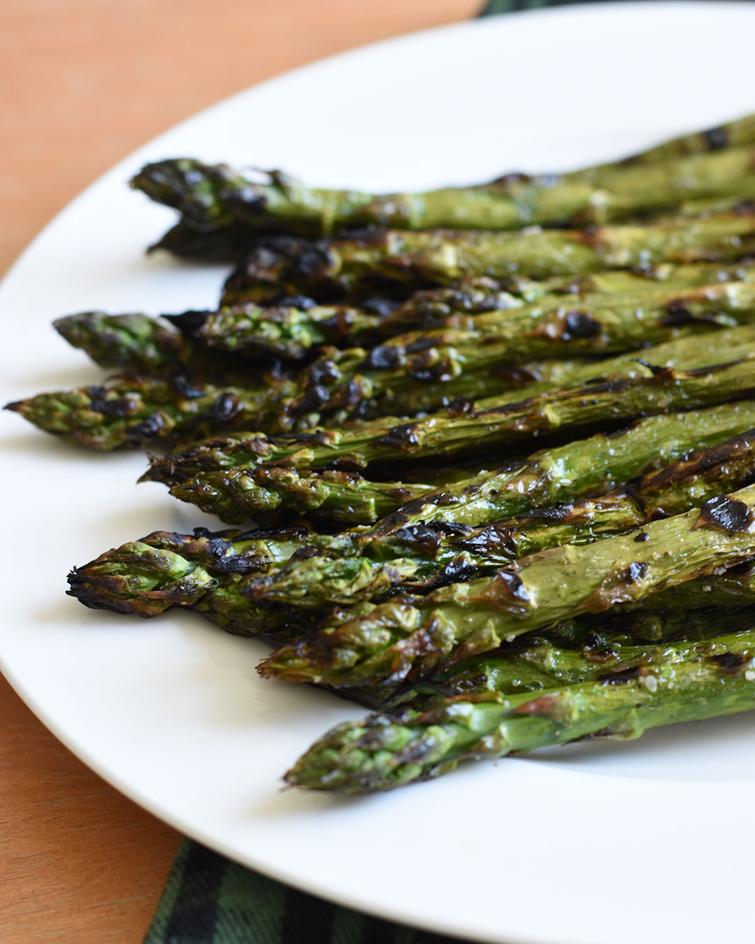 grilled asparagus on white plate